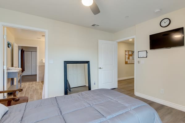 Interior view of a private room with a bed and TV