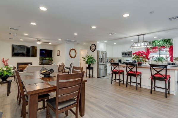 Bright, welcoming common area with dining table and kitchen