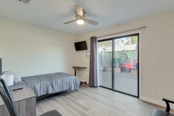 A private resident room with a bed and patio doors