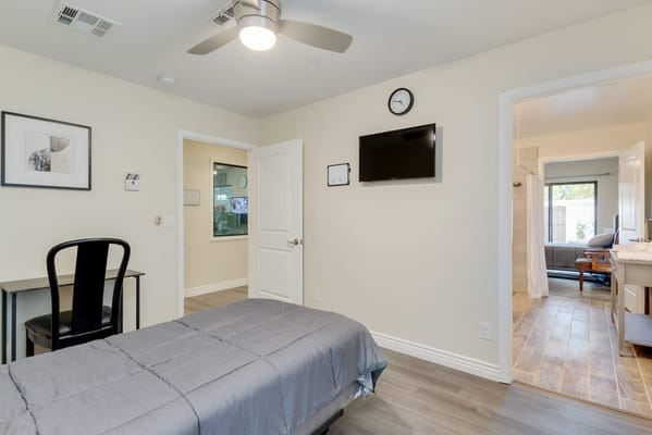 A private resident room with a bed and desk