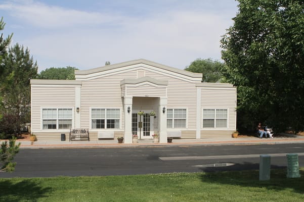Exterior view of the assisted living facility with residents.