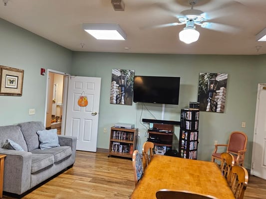 Bright common area with seating and entertainment options