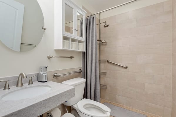 Bright and clean resident bathroom with safety features