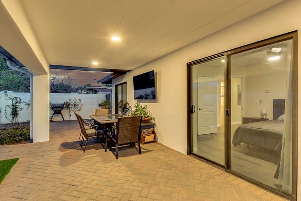 Outdoor seating area with view of a room and garden