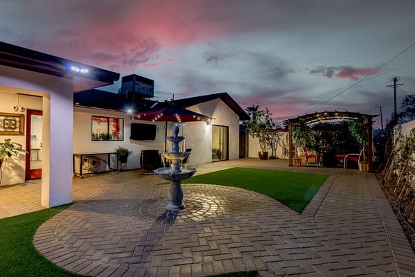 Outdoor space featuring a fountain and patio.