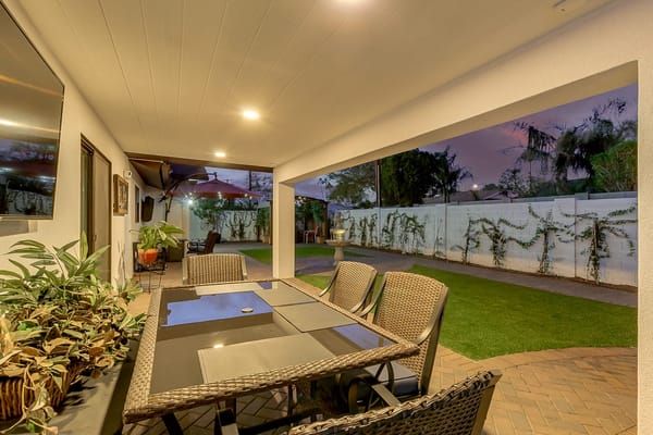Covered outdoor seating area with garden view