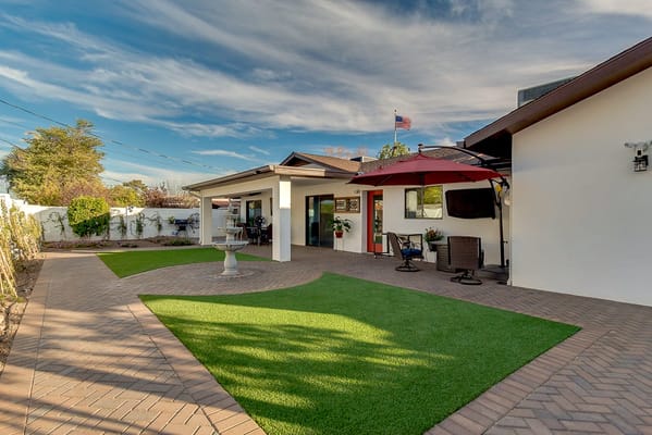 Outdoor patio area with seating and greenery