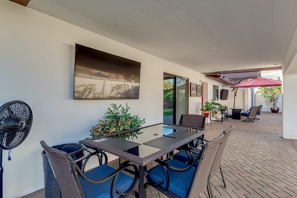 Outdoor seating area with a dining table and plants