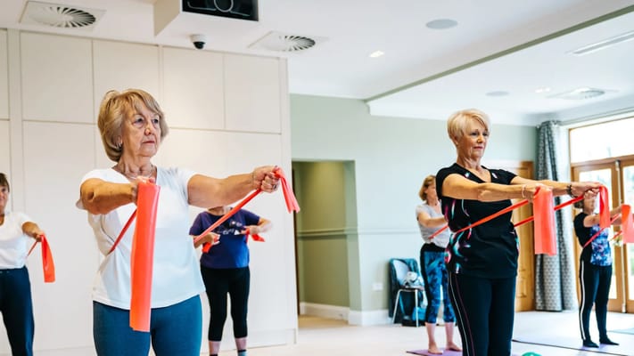 Residents participating in a gentle exercise class indoors