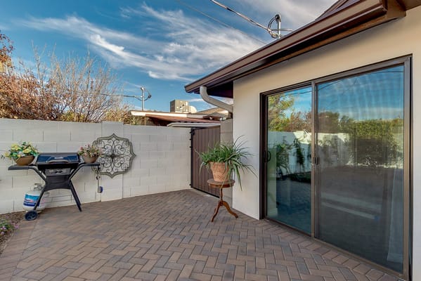 Quaint outdoor patio with grill and plants