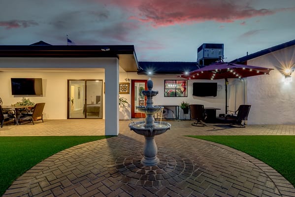 Outdoor patio area with seating and fountain
