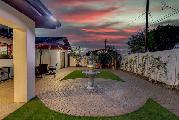 Outdoor patio area with a fountain and chairs