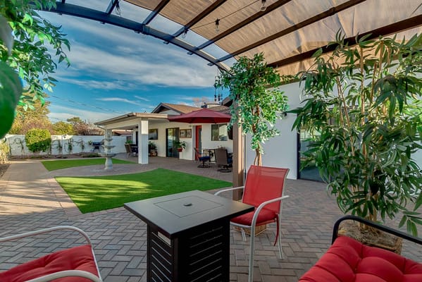 Outdoor patio area with seating and greenery