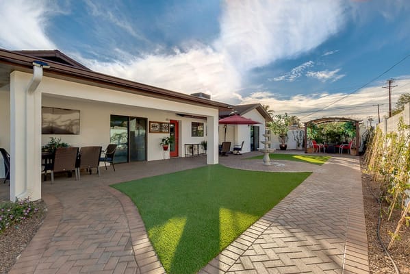 Spacious outdoor area with seating and greenery