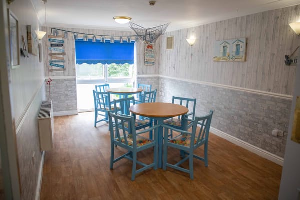 Bright common area with blue furniture and decor