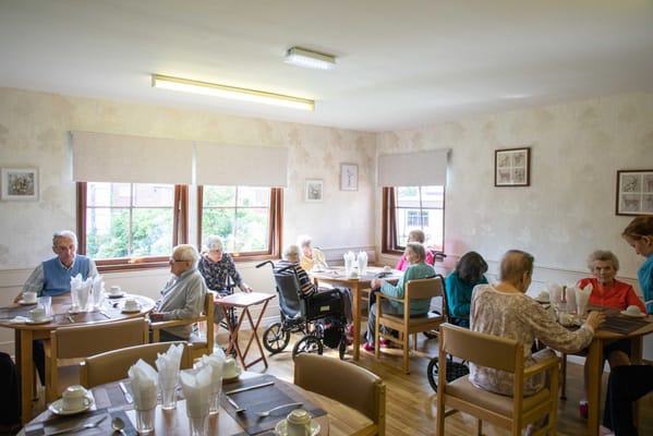 Residents engaging in activities in a dining room