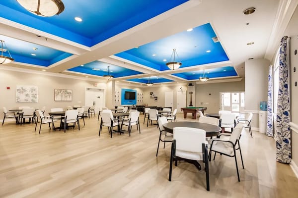 Bright common area with tables and chairs