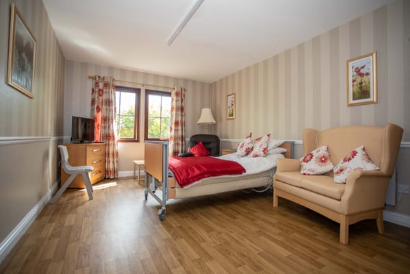 Private resident room with bed and seating area