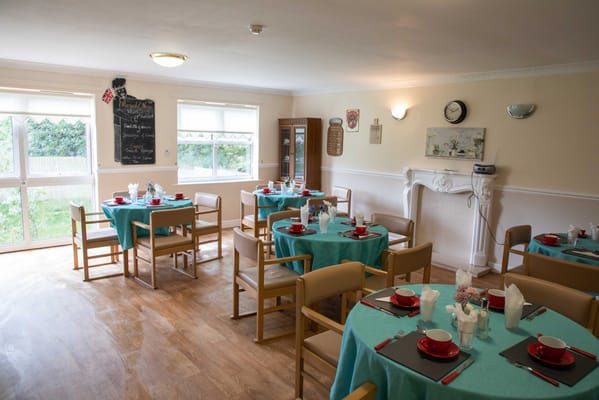 Bright dining room with tables set for meals