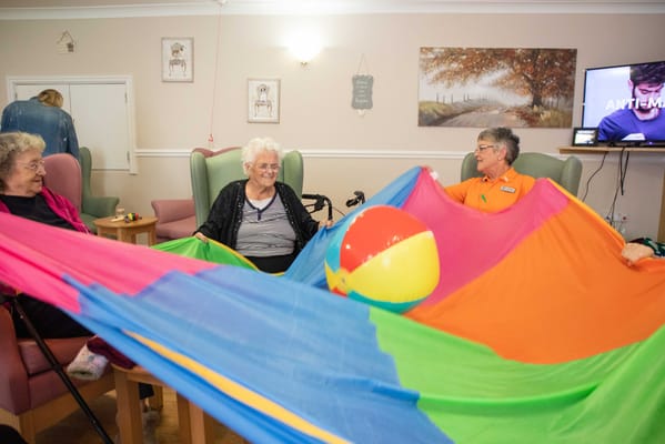 Residents enjoying a colorful activity with a staff member