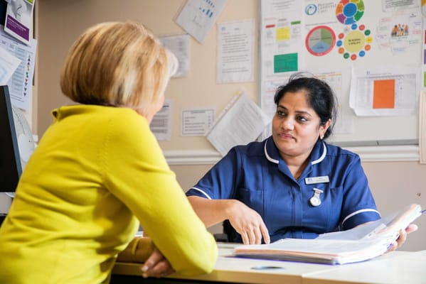 Nurse consulting with a resident in an office