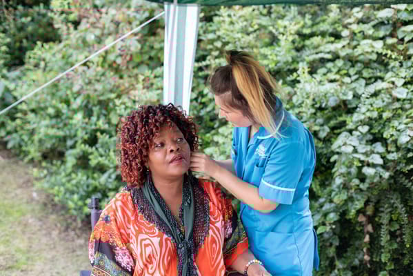 Staff member assisting resident outdoors