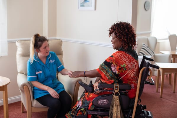 Staff member interacting with a resident in a common area