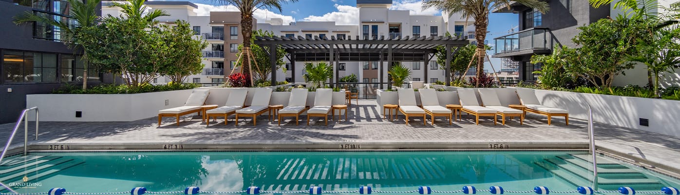Outdoor pool area with lounge chairs and landscaping