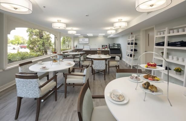 Bright dining room with tables set for tea and snacks