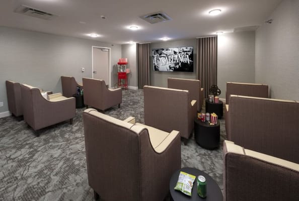 Common area with seating and a movie screen