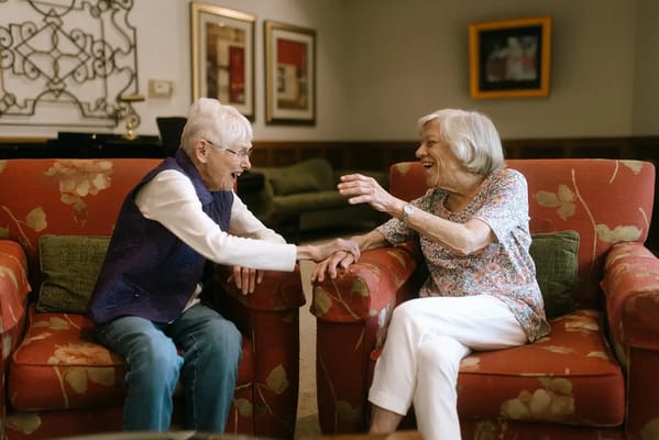 Two residents enjoying conversation in a common area