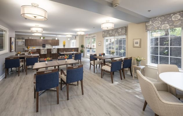 Bright dining room with tables and chairs set up for meals