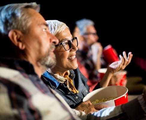 Residents enjoying a movie with popcorn