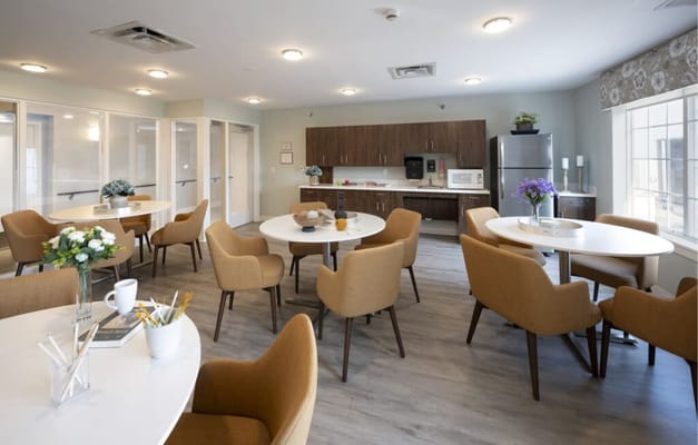 Bright common area with dining tables and chairs