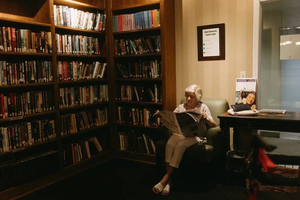 Resident reading in a cozy library area