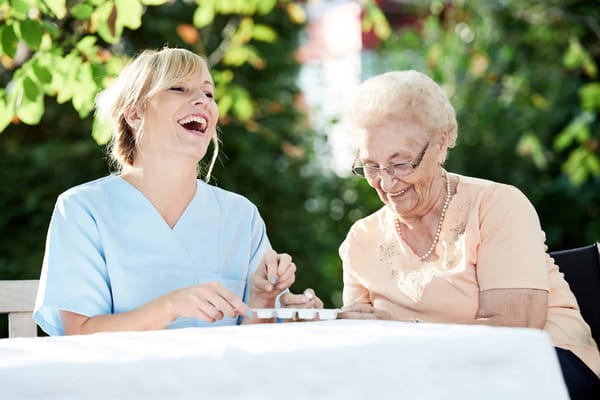 A staff member and a resident enjoying time outdoors