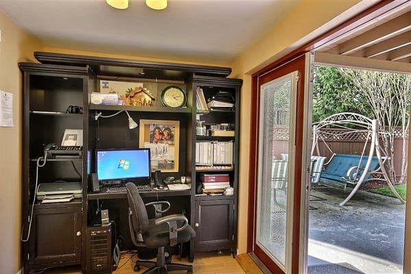 An interior office space with a view of a patio swing