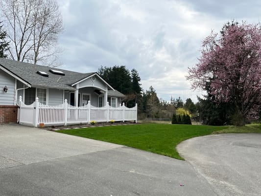 Exterior view of a senior living facility with landscaped yard
