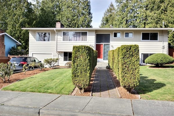Exterior view of a senior living facility with landscaped yard
