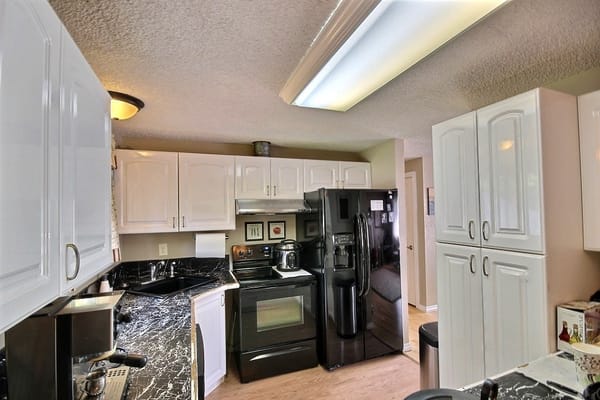 Interior view of a kitchen with cabinets and appliances
