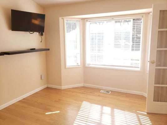 Bright interior room with natural light and wooden flooring