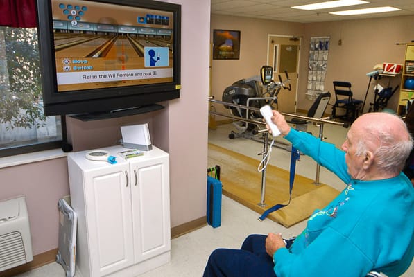 Resident participating in a Wii bowling activity