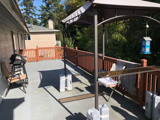 Outdoor seating area with a canopy and grill