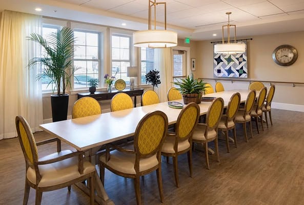 Bright dining room with yellow chairs and large table