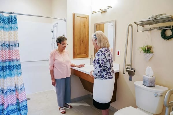 Residents interacting in a bathroom setting