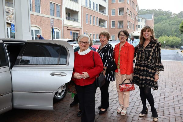 Residents arriving in a vehicle, smiling and socializing