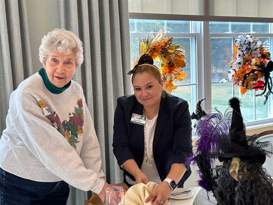 Resident and staff member preparing for a celebration