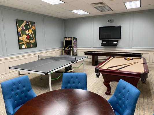 Game room with a pool table and ping pong table