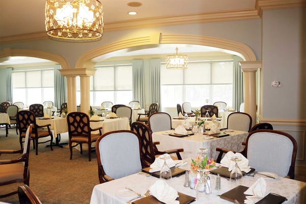 Elegant dining room setup with flowers and table settings