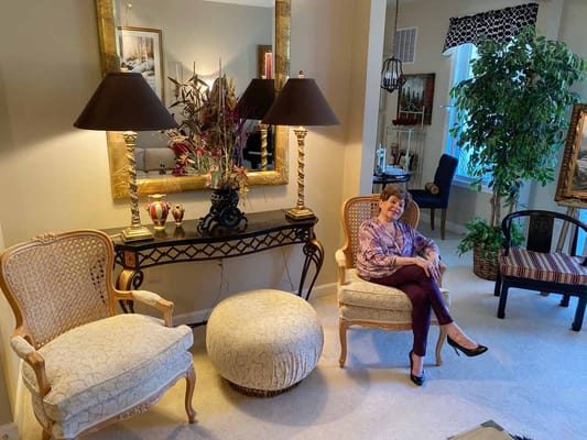 Resident sitting in a cozy living area with decorative furnishings